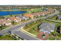 Beautiful aerial view showcases the community's houses, golf course, and serene lake at 4705 Tortona Ct, Bradenton, FL 34211
