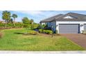 Well-maintained home with a gray garage door and lush landscaping at 4705 Tortona Ct, Bradenton, FL 34211