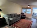 Cozy living room with plush seating, dark floors, and a vibrant area rug creating a warm and inviting atmosphere at 6099 Coral Way, Bradenton, FL 34207