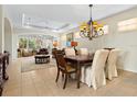 Elegant dining room with a large table and chandelier at 6642 Tailfeather Way, Bradenton, FL 34203