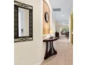 Bright entryway with a half-wall table and mirror at 6642 Tailfeather Way, Bradenton, FL 34203