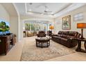 Spacious living room featuring leather furniture and a large TV at 6642 Tailfeather Way, Bradenton, FL 34203