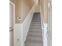 Interior view of a carpeted staircase with white railings at 8133 Miramar Way # 201, Lakewood Ranch, FL 34202