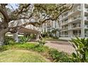 Landscaped entryway with a brick driveway and a unique covered walkway at 1111 N Gulfstream Ave # 6B, Sarasota, FL 34236