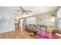Bright and airy living room with a comfy couch and hardwood floors at 2111 Outer Dr, Sarasota, FL 34231