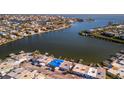 Expansive aerial view showcases waterfront homes with private docks and serene water views at 23 Seaside Ct, Holmes Beach, FL 34217