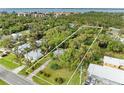 Aerial view of residential property with waterfront access and lush landscape at 25318 Marion Ave, Punta Gorda, FL 33950