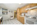 White appliances and wood cabinets in this kitchen at 3213 Sumac Ter, Sarasota, FL 34237