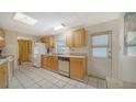 Bright kitchen with wood cabinets and tile floor at 3213 Sumac Ter, Sarasota, FL 34237