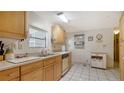 Kitchen with wood cabinets, tile flooring, and appliances at 3213 Sumac Ter, Sarasota, FL 34237