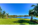 Serene backyard oasis with lush landscaping and lake view at 5616 107Th E Ter, Parrish, FL 34219