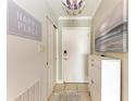 Bright and airy entryway with a white dresser and decor at 115 Tyler Dr # 203, Sarasota, FL 34236