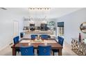 Spacious dining area with a large wooden table and blue velvet chairs at 17333 Sabrina Cir, Port Charlotte, FL 33948