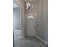 Bright entryway features a stylish light fixture and tiled flooring at 2063 Lynx Run, North Port, FL 34288