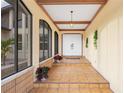 Bright and airy entryway with tiled floors and potted plants at 220 Ciboa Ave, North Port, FL 34287
