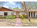 Front entrance and landscaping with a walkway at 2807 Country River Dr, Parrish, FL 34219