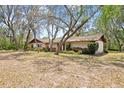 Long view of the home's exterior, showing its length and landscaping at 2807 Country River Dr, Parrish, FL 34219