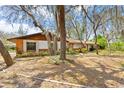 Brick home with mature oak trees and a walkway to the entrance at 2807 Country River Dr, Parrish, FL 34219