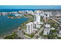 Aerial view of waterfront property, showcasing a modern building and marina at 711 S Palm Ave # 203, Sarasota, FL 34236