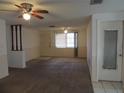 Spacious living room featuring carpet and a ceiling fan at 3245 Roxbury Dr, Holiday, FL 34691