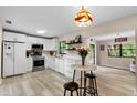 Bright kitchen features white cabinets, stainless steel appliances, and light wood flooring at 3415 51St Avenue W Cir # 206, Bradenton, FL 34210