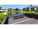 Community deck overlooking a pond with a bench, offering a relaxing view at 3609 59Th W Ave # 4045, Bradenton, FL 34210