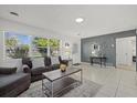 Bright and airy living room featuring a comfortable couch and large windows at 5315 24Th St W, Bradenton, FL 34207