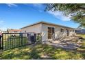Rear view of the house, showcasing a patio area and access gate to the backyard at 6415 Coliseum Blvd, Port Charlotte, FL 33981