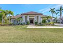 Modern home with tile roof and walkway, surrounded by tropical landscaping at 7003 River Club Blvd, Bradenton, FL 34202