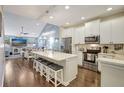 Modern kitchen with white cabinets, quartz countertops, and stainless steel appliances at 11717 Meadowgate Pl, Bradenton, FL 34211