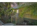 Inviting entrance to a yellow cottage featuring stairs and a screened porch at 16102 Camas Ave, Port Charlotte, FL 33954