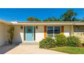 Inviting front entrance with a light blue door and landscaping at 3353 Kenmore Dr, Sarasota, FL 34231