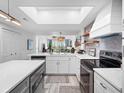 Modern kitchen with white cabinets, quartz countertops, and stainless steel appliances at 4204 126Th W St # 506, Cortez, FL 34215