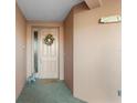 Condo entryway with tile floors and a beige door at 5209 Manorwood Dr # 3A, Sarasota, FL 34235