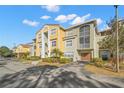 Bright, multi-level condo building showcasing modern architecture and lush landscaping at 5601 Bentgrass Dr # 10-112, Sarasota, FL 34235