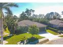 Single-story house with a tile roof, located on a tree-lined street at 5868 Meriwether Pl, Sarasota, FL 34232