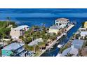 Aerial view of property on the water with private dock at 834 Jungle Queen Way, Longboat Key, FL 34228
