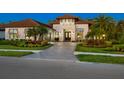 House exterior at dusk showcasing landscaping and driveway at 9224 Starry Night Ave, Sarasota, FL 34241