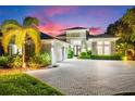 Evening view of home with landscape lighting at 931 Bayshore Rd, Nokomis, FL 34275