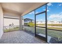 Covered patio overlooking the yard and pond, ideal for relaxing outdoors at 11380 Burgundy Dr, Venice, FL 34293