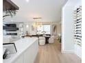 Bright dining area with modern chandelier and hardwood floors at 1233 N Gulfstream Ave # 301, Sarasota, FL 34236