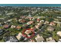 Aerial view highlighting a single-story home in a residential neighborhood near the water at 148 Inlets Blvd # 148, Nokomis, FL 34275