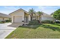 Single-story home with attached garage and landscaped front yard at 148 Inlets Blvd # 148, Nokomis, FL 34275