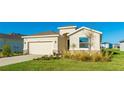 Tan house with a black door, stone accents, and a neatly landscaped front yard at 15813 6Th E Ave, Bradenton, FL 34212