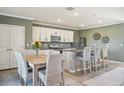 Bright kitchen with granite countertops, a modern island with seating, and stainless steel appliances at 17113 Reserva Dr, Bradenton, FL 34211