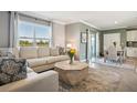 Open-concept living room flows into dining area, offering view and bright interior at 17113 Reserva Dr, Bradenton, FL 34211