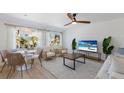Open concept living area with comfortable seating, dining table, and large TV at 303 65Th St # A, Holmes Beach, FL 34217