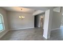 Dining Room with modern chandelier and lots of light with view into kitchen area at 3325 Stockton Ave, North Port, FL 34286
