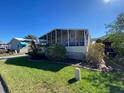 Mobile home features a screened porch and spacious yard at 4851 W Gandy Blvd # 5Pa, Tampa, FL 33611