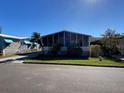 Mobile home with a large screened porch and landscaped yard at 4851 W Gandy Blvd # 5Pa, Tampa, FL 33611